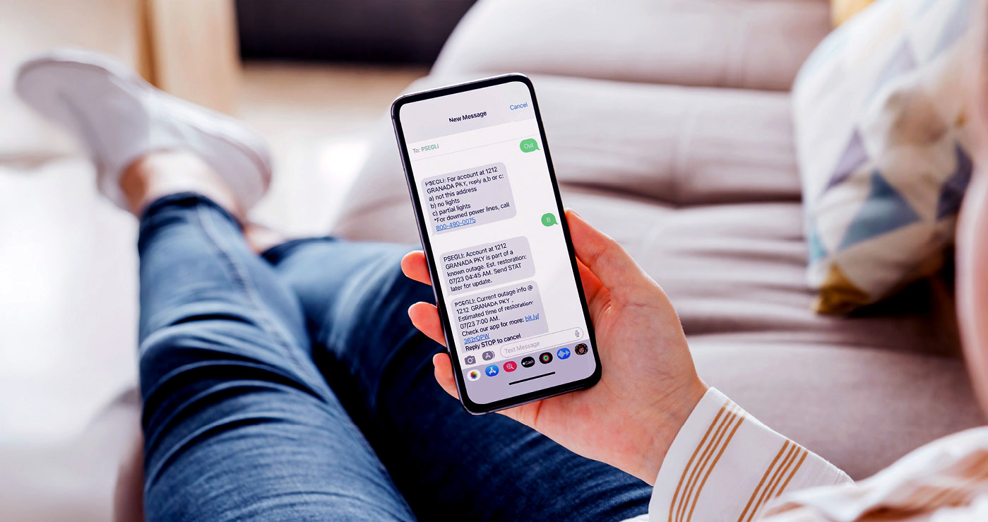 Female executive on a street looking at her smartphone