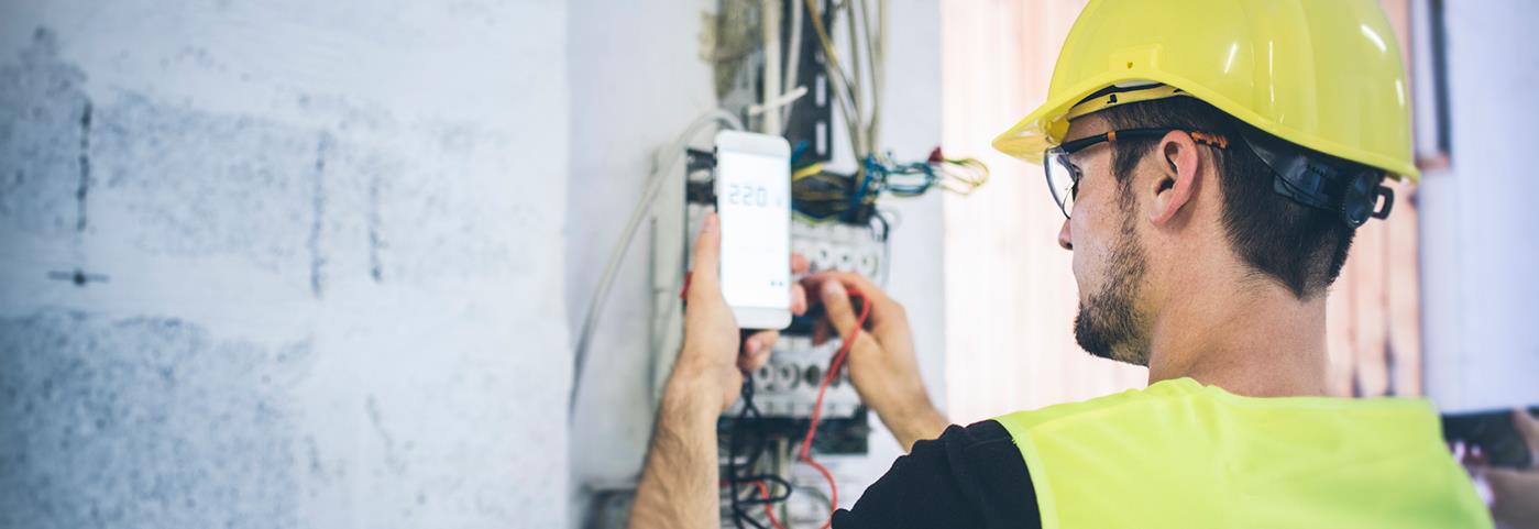 Man inspecting wires or a meter