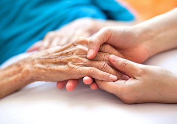 Older woman, wearing glasses & sitting