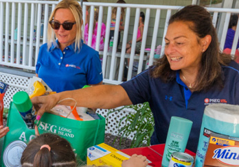 An executive listening to an audience member during a presentation