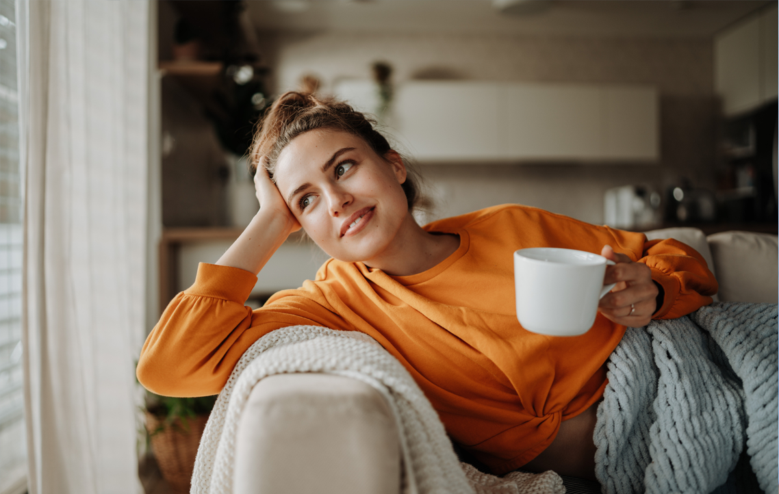 Man drinking coffee and looking out window