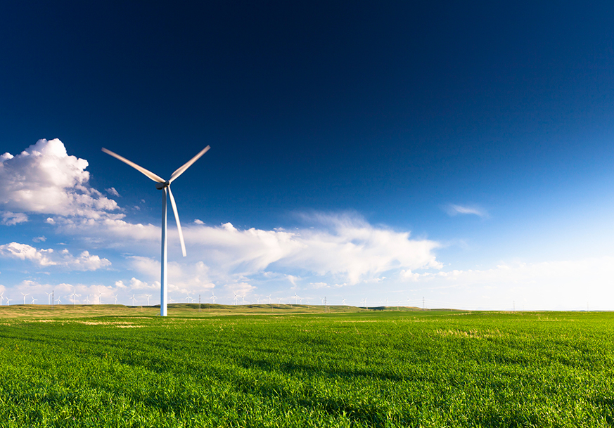 A windmill in a green field