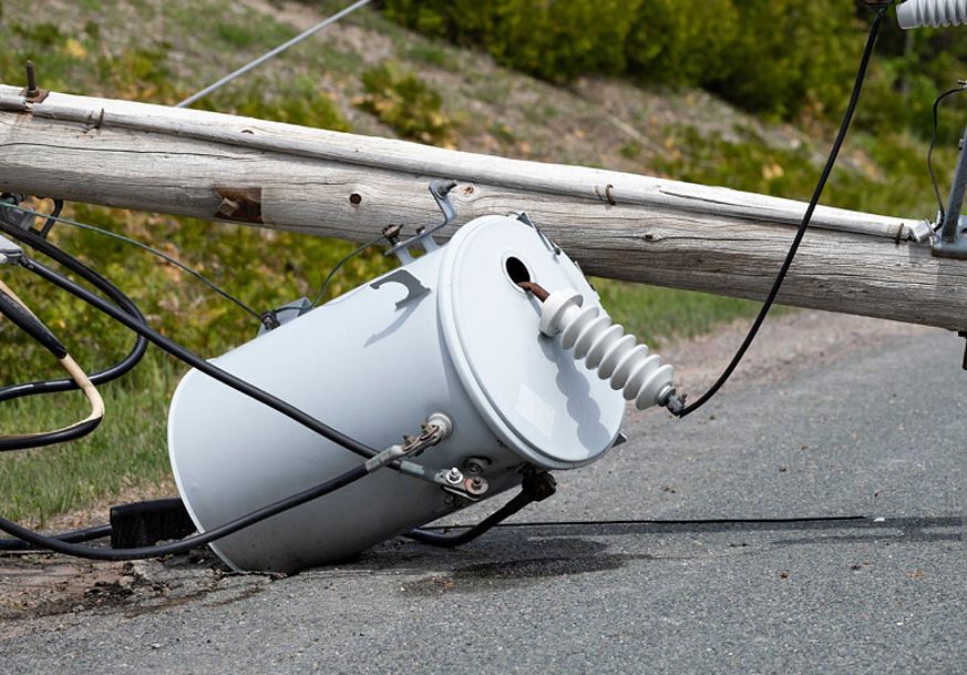Transmission towers and power lines at sunset
