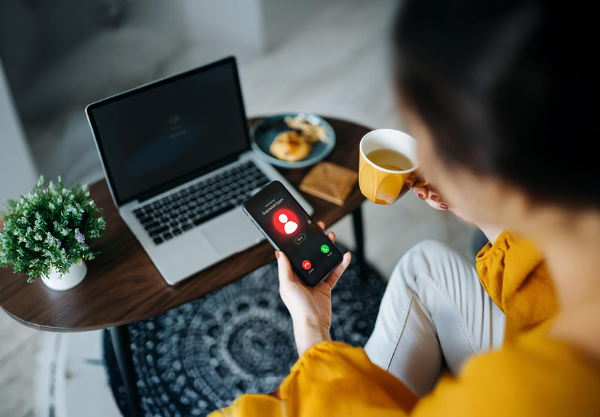 White computer keyboard with a big red button that says scam