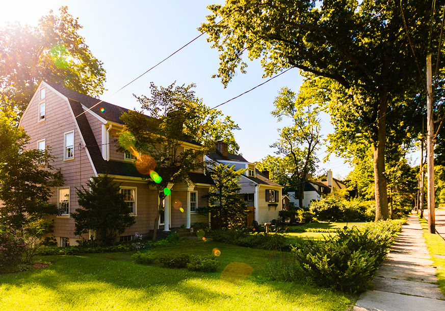 A suburban home with several trees planted safely away from power lines