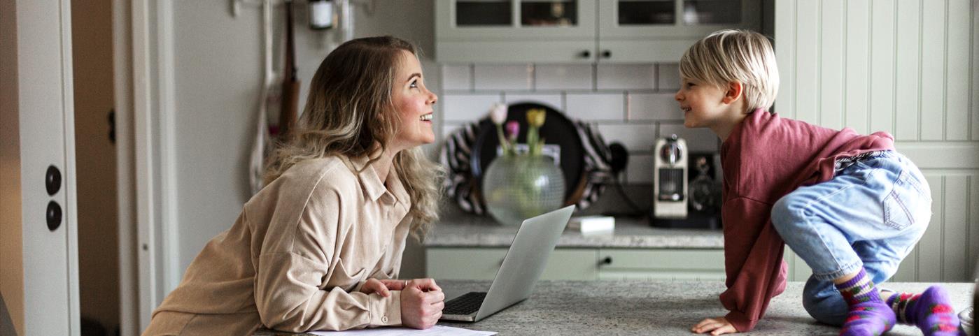 Man in kitchen with son looking at LED