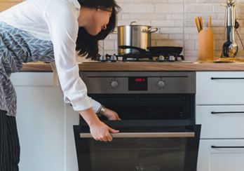 Woman opening oven