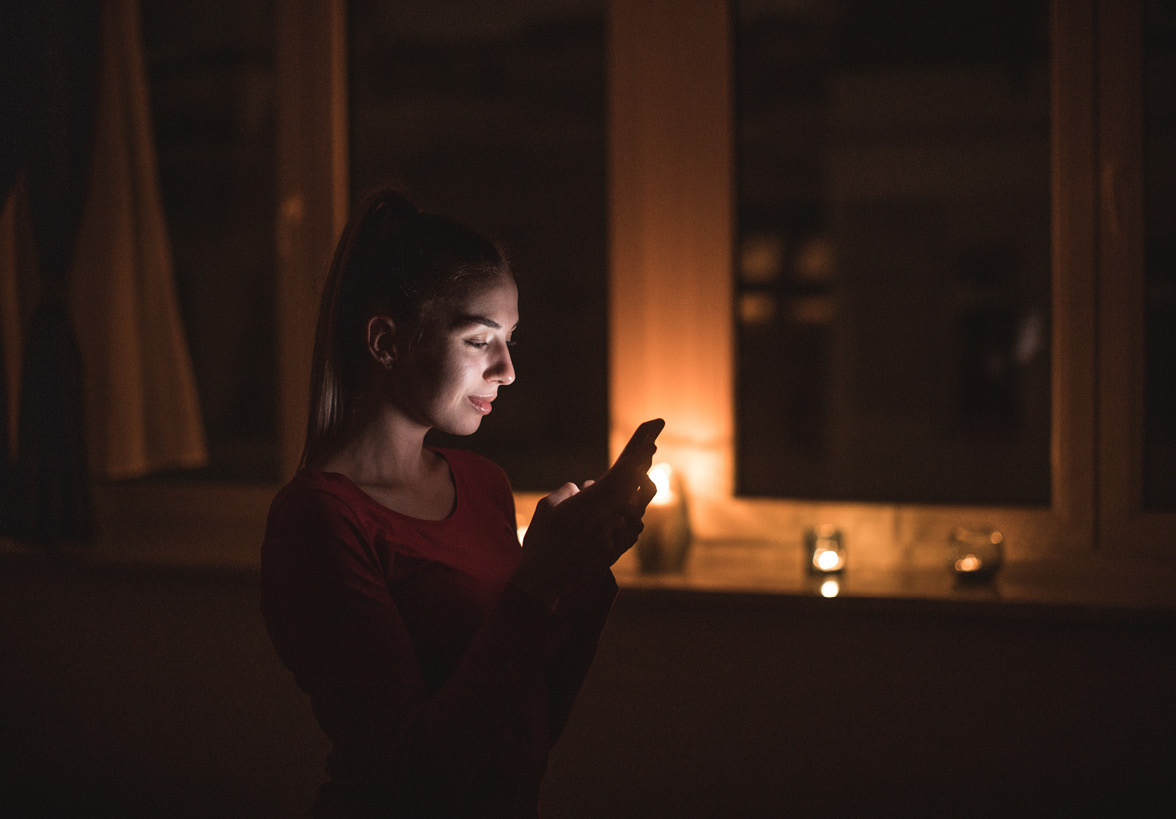 Man looking at phone during a power outages