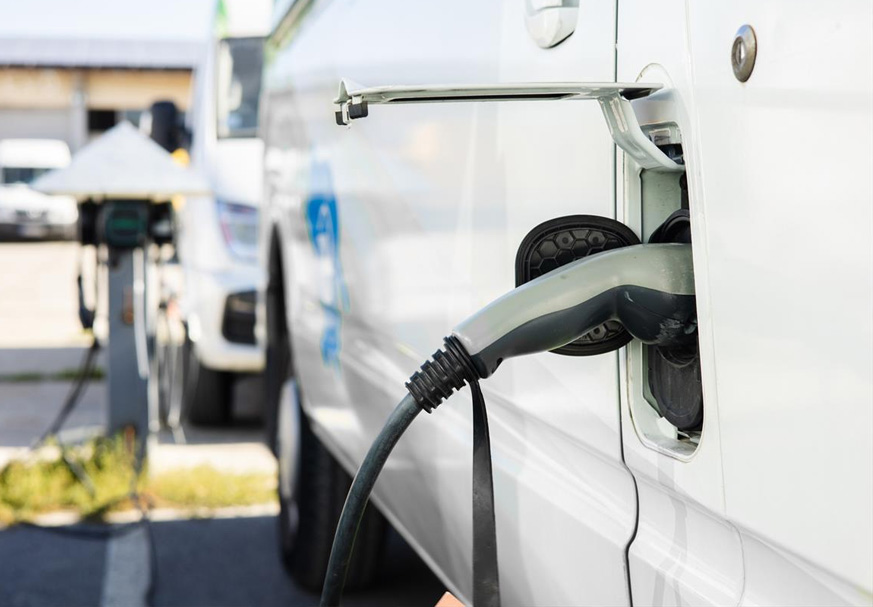 white ev getting charged