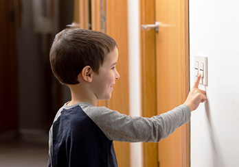 boy turning off lights